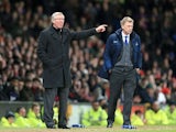 Manchester United manager Sir Alex Ferguson and Everton manager David Moyes watch their side's in action on February 10, 2013