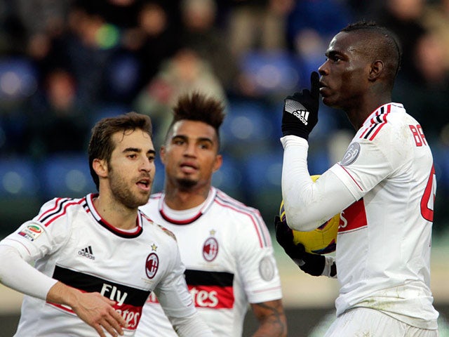 Milan's Mario Balotelli celebrates with team mates after scoring the equaliser against Cagliari on February 10, 2013