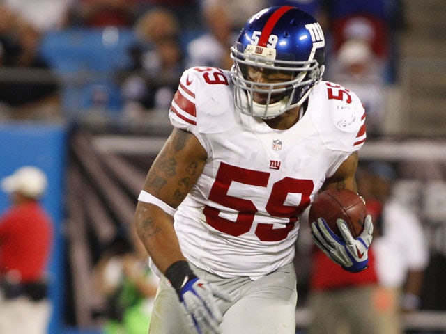 New York Giants player Michael Boley runs with the ball after making an interception during his side's match against the Carolina Panthers on September 20, 2012