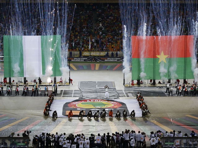 Flares go off next to the flags of Nigeria and Burkina Faso during the closing ceremony of the African Cup of Nations on February 10, 2013