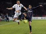 Paris Saint Germain's defender Gregory Van Der Wiel challenges for the ball on February 8, 2013