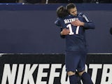 Paris Saint Germain's midfielder Jeremy Menez is congratulated after scoring by his teammate Maxwell on February 8, 2013