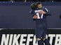 Paris Saint Germain's midfielder Jeremy Menez is congratulated after scoring by his teammate Maxwell on February 8, 2013