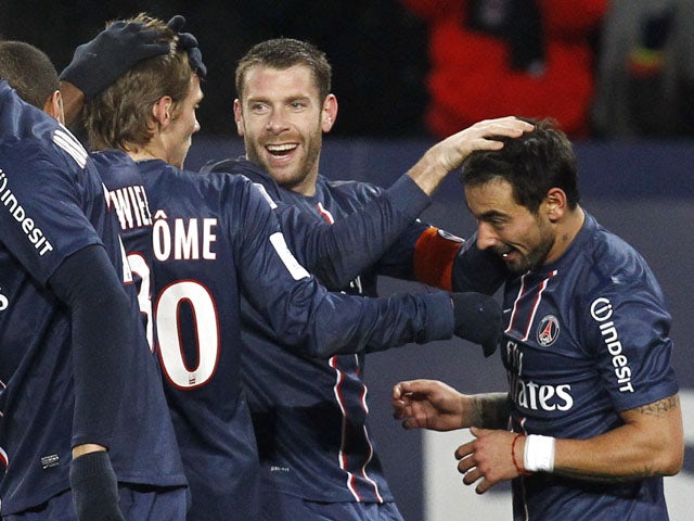 Paris Saint Germain's forward Ezequiel Lavezzi is congratulated by teammates after scoring in his side's match with Bastia on February 8, 2013