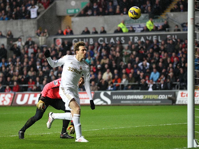 Swansea City forward Michu scores his side's first goal against QPR on February 9, 2013