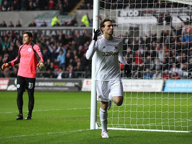 Swansea City forward Michu celebrates after scoring his side's first goal against QPR on February 9, 2013