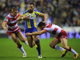 Warrington Wolves player Ryan Atkins is tackled by Wigan Warriors player Matty Smith on February 8, 2013
