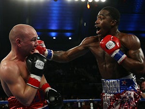 Adrien Broner throws a punch at Gavin Rees during their WBC lightweight title match on February 17, 2013