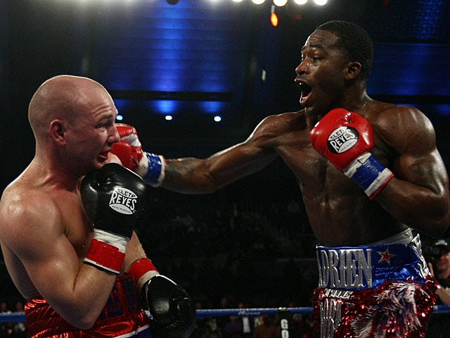 Adrien Broner throws a punch at Gavin Rees during their WBC lightweight title match on February 17, 2013