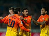 Barcelona's Lionel Messi is congratulated by team mates after scoring his second goal against Granada on February 16, 2013