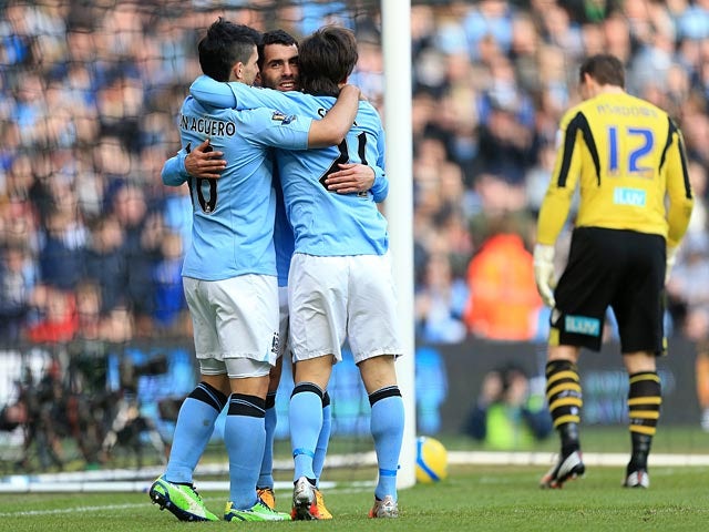 Manchester City's Carlos Tevez is congratulated by David Silva and Sergio Aguero after scoring his team's third against Leeds in the FA Cup 5th round on February 17, 2013