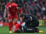 Stewart Downing checks on team mate Fabio Borini as he is attended to by the physio after picking up an injury during the match against Swansea on February 17, 2013