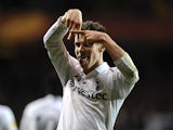 Gareth Bale celebrates after scoring his second in the Europa League match against Lyon on February 14, 2013