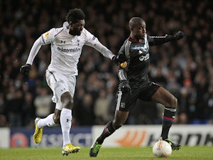Tottenham Hotspur's Emmanuel Adebayor and Lyon's Gueida Fofana battle for the ball on February 14, 2013