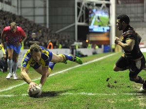 Warrington's Joel Monaghan dives in a try against Catalan Dragons on February 15, 2013