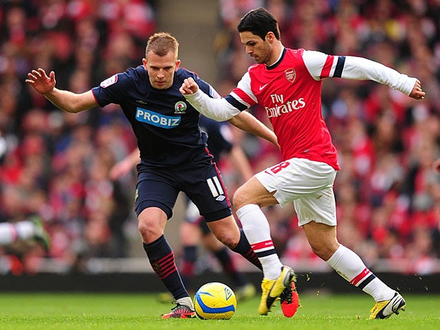 Arsenal's Mikel Arteta and Blackburn's Jordan Rhodes battle for the ball during the FA Cup fifth round tie on February 16, 2013