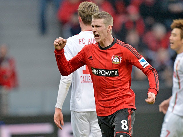 Leverkusen's Lars Bender celebrates scoring the his team's second against Augsburg on February 16, 2013