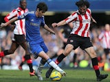 Chelsea's Oscar and Brentford's Jonathan Douglas battle for the ball in their FA Cup 4th round replay on February 17, 2013