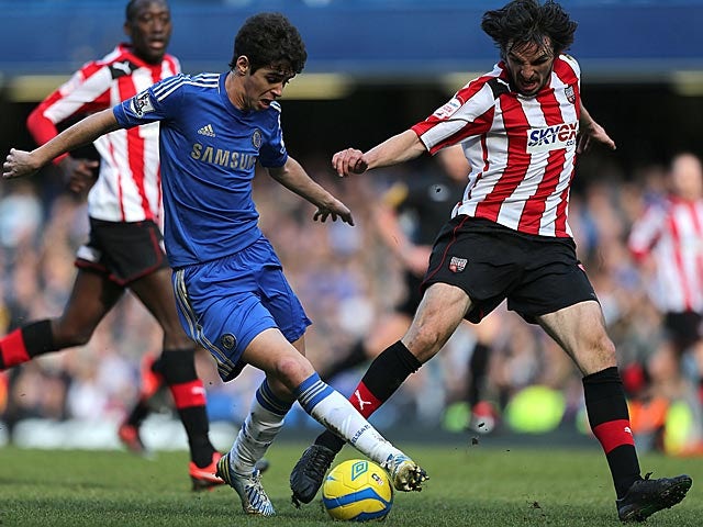 Chelsea's Oscar and Brentford's Jonathan Douglas battle for the ball in their FA Cup 4th round replay on February 17, 2013