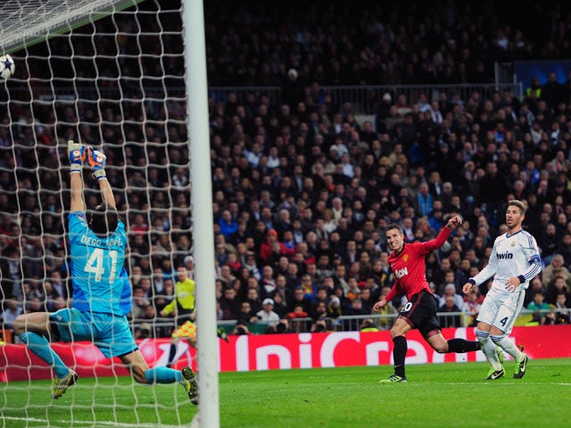 Manchester United striker Robin van Persie has his shoot tipped onto the bar on February 13, 2013