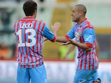 Catania's Sergio Almiron is congratulated by team mate Mariano Izco after scoring the opener against Bologna on February 17, 2013