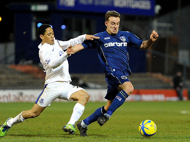 Everton's Steven Pienaar and Oldham's Jose Baxter battle for the ball during their FA Cup 5th round match on February 16, 2013