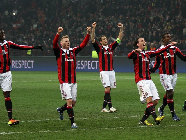 AC Milan players celebrate after defeating Barcelona on February 20, 2013