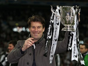 Swansea City manager Michael Laudrup celebrates with the Capital One Cup final trophy on February 24, 2013