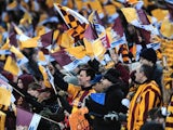 Bradford fans continue their support, with their team losing 4-0 to Swansea on February 24, 2013
