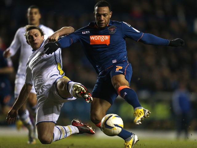 Leeds United's Stephen Warnock and Blackpool's Matt Phillips battle for the ball on February 20, 2013