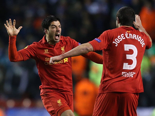 Liverpool's Luis Suarez celebrates with team mate Jose Enrique after scoring his team's third against Zenit St Petersburg on February 21, 2013