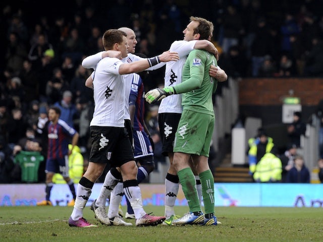 Fulham players congratulate Mark Schwarzer, after his penalty save help them beat Stoke City 1-0 on February 23, 2013