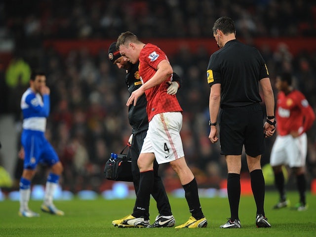 Man Utd defender Phil Jones leaves the field injured against Reading on February 18, 2013