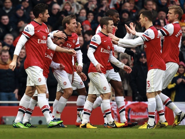 Arsenal players congratulate Santi Cazorla after a goal against Aston Villa on February 23, 2013