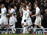 Spurs players congratulate Aaron Lennon after he put them 2-0 up against Arsenal on March 3, 2013