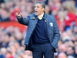 Norwich City manager Chris Hughton gives instructions on the touchline during his side's match against Manchester United on March 2, 2013
