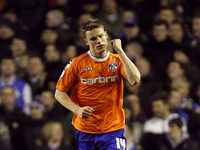 Oldham's Matt Smith celebrates after scoring in the FA Cup 5th round replay against Everton on February 26, 2013