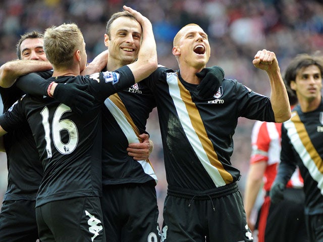 Fulham players celebrate with goalscorer Dimitar Berbatov after he converted a penalty kick against sunderland on March 2, 2013