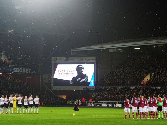 West Ham United and Tottenham Hotspur players stand in memory of ex-West Ham United player and England captain Bobby Moore prior to kick off on February 25, 2013