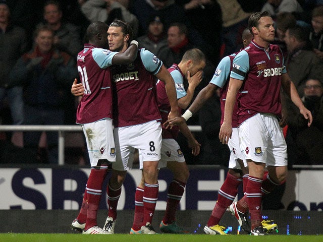 West Ham's Andy Carroll celebrates with teammates after scoring against Tottenham Hotspur on February 25, 2013