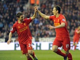 Liverpool's Stewart Downing celebrates with teammate Joe Allen after scoring against Wigan on March 2, 2013