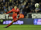 Liverpool's Luis Suarez scores from a free kick against Wigan on March 2, 2013