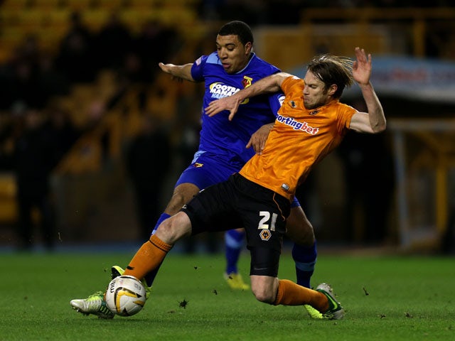 Wolverhampton Wanderers Kaspars Gorkss is tackled by Watford's Troy Deeney during the Championship match on March 1, 2013