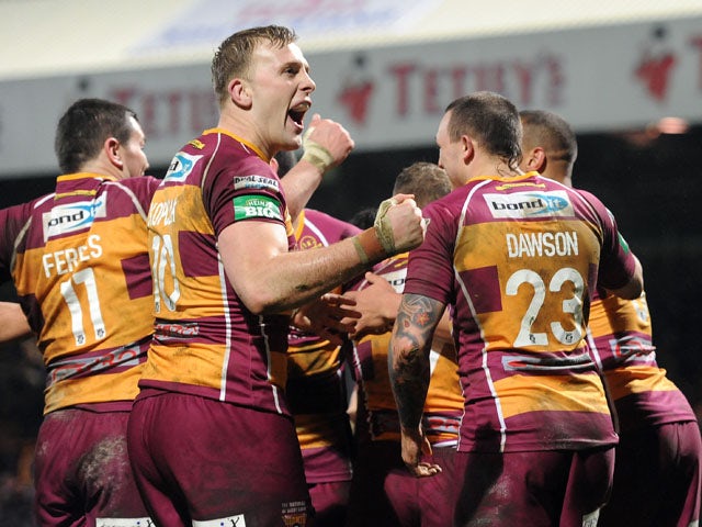 Huddersfield Giants players celebrate after Scott Grix scores a try during the Super League match against Leeds Rhinos on March 8, 2013