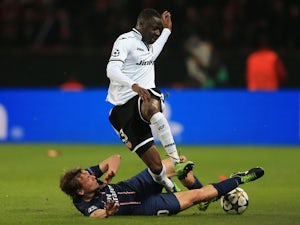 Paris Saint-Germain's Clement Chantome and Valencia's Aly Cissokho battle for the ball on March 6, 2013
