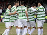 Celtic players celebrate with goalscorer Charlie Mulgrew after his goal against Ross County on March 9, 2013