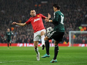 Manchester United's Ryan Giggs and Real Madrid's Mesut Ozil battle for the ball on March 5, 2013
