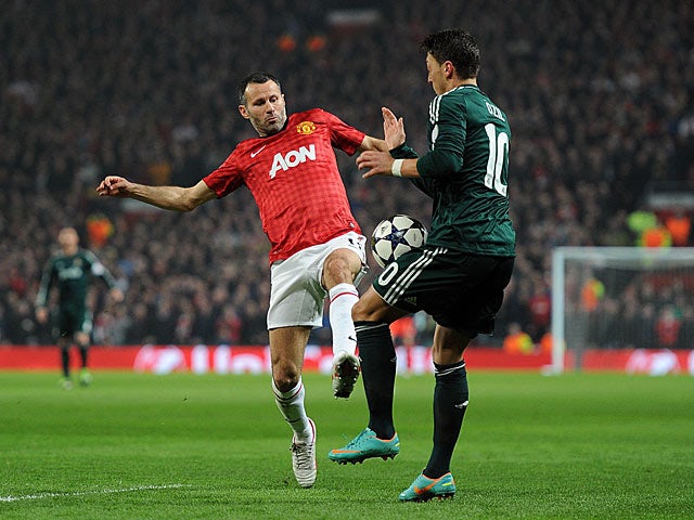 Manchester United's Ryan Giggs and Real Madrid's Mesut Ozil battle for the ball on March 5, 2013