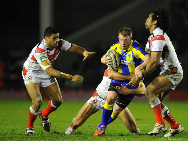 Warrington Wolves' Chris Riley is tackled by St Helens players during the Super League clash on March 8, 2013