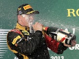 Lotus driver Kimi Raikkonen celebrates with champagne after winning the Australian Formula One Grand Prix on March 17, 2013